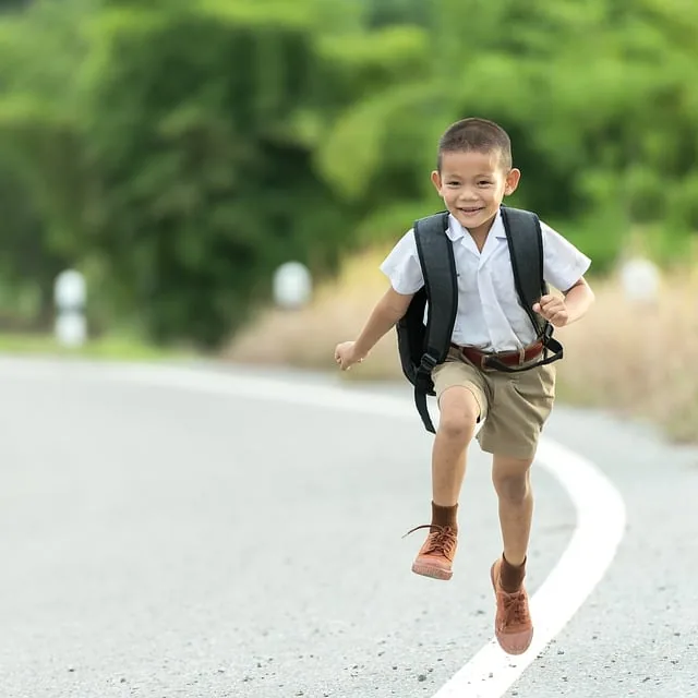 A school-aged boy running