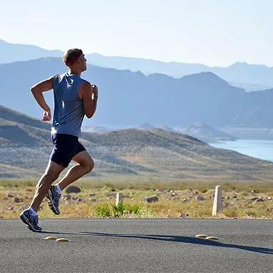 A runner on a downhill road
