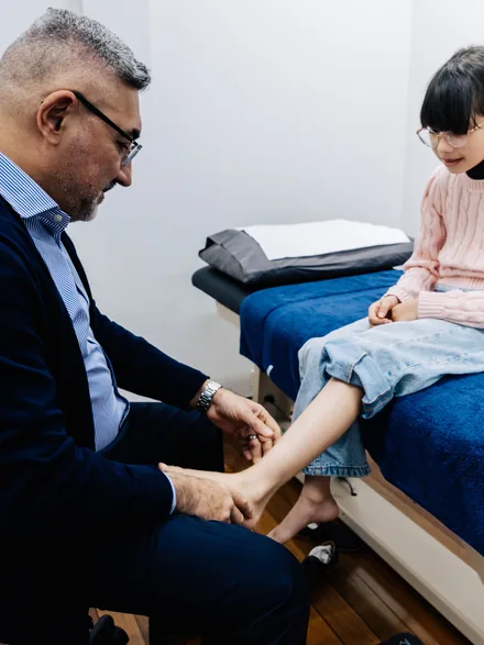 Dr Abbie Najjarine assessing a child’s foot in clinic