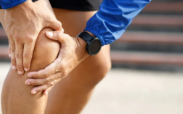 A runner holding their knee