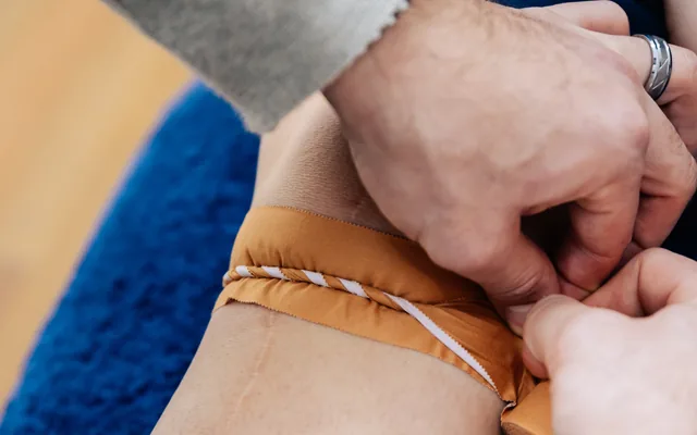 Therapeutic strapping being applied to a patient’s foot